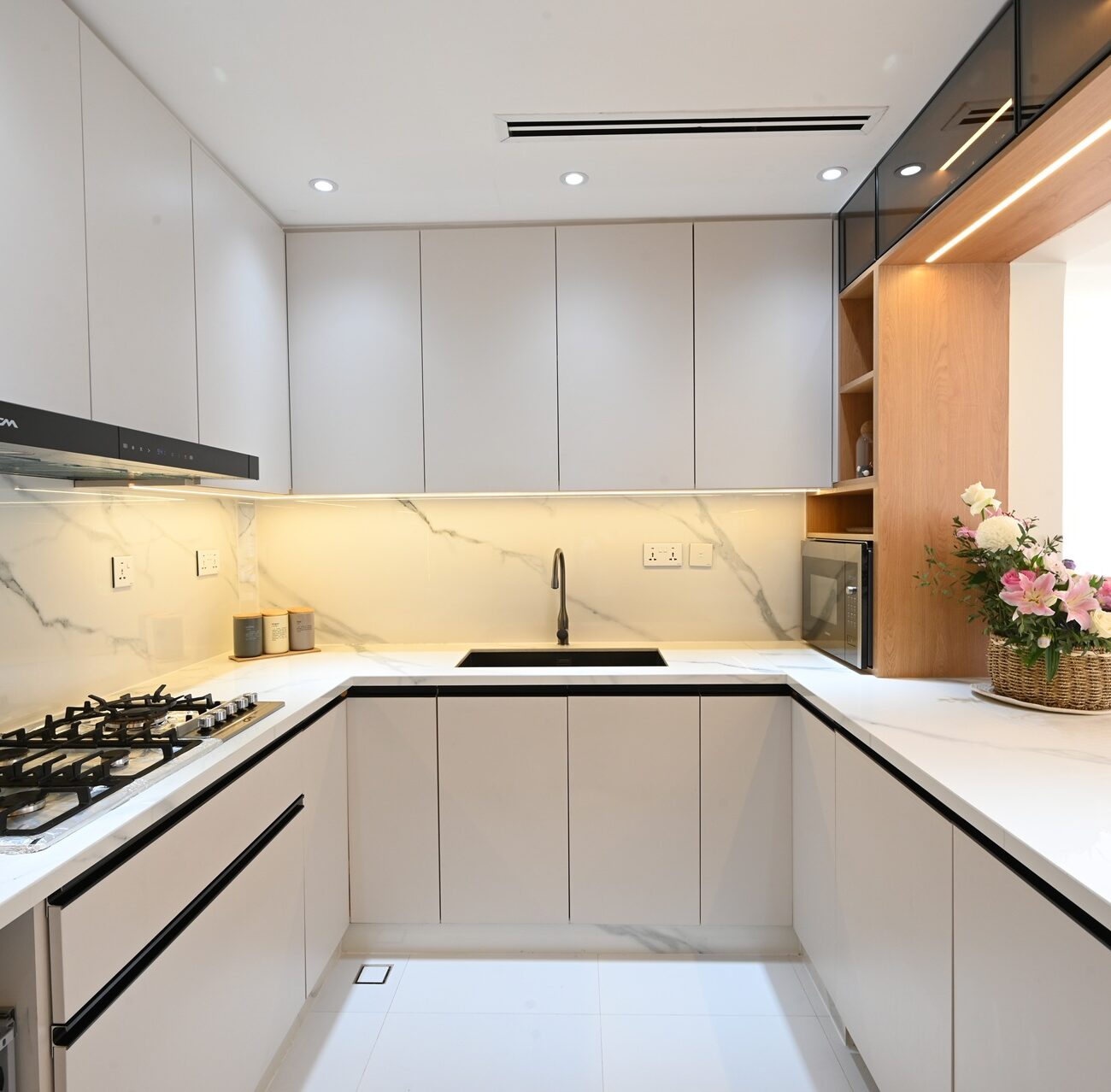 Open-plan kitchen with marble countertop in JVT Dubai villa